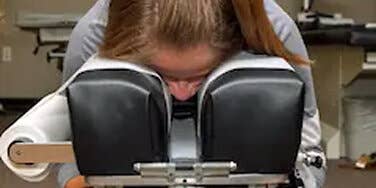 Person lying face down on table